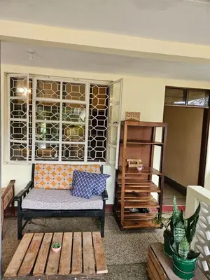 a living room with a bench and a window at Kiwavi Home in Moshi