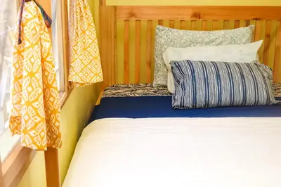 a bed sitting next to a window in a room at Kiwavi Home in Moshi