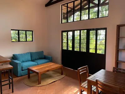 a living room with a blue couch and a table at Lilac Hideaway in Karatu