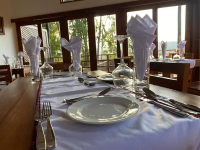 a table with a plate on a blue table cloth at Lilac Hideaway in Karatu