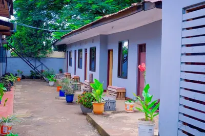 a house with potted plants in front of it at The Better Inn in Moshi