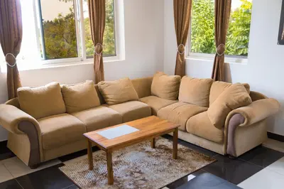 a living room with a couch and a coffee table at Two Mountains Lodge in Arusha