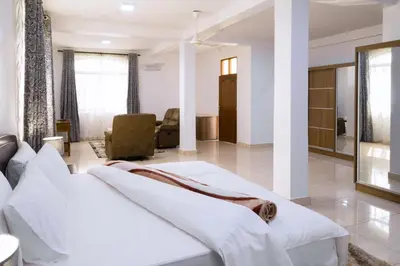 a bedroom with two beds in a room at Two Mountains Lodge in Arusha