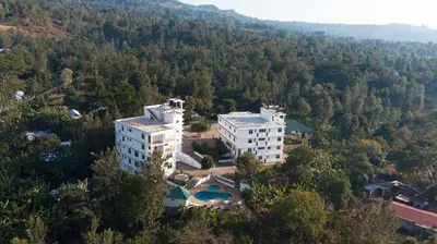 an aerial view of a building in the middle of a forest at Two Mountains Lodge in Arusha