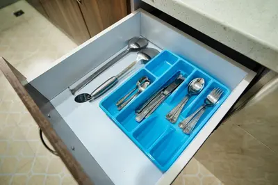 a blue tray with silver utensils in a drawer at Kibo Palace Apartments in Arusha