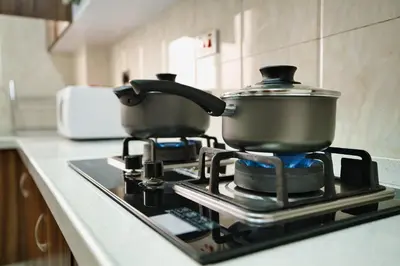 two pots sitting on top of a stove in a kitchen at Kibo Palace Apartments in Arusha