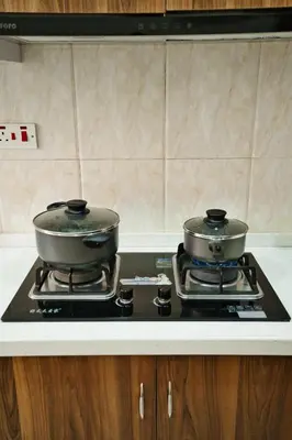 two pots sitting on top of a stove in a kitchen at Kibo Palace Apartments in Arusha