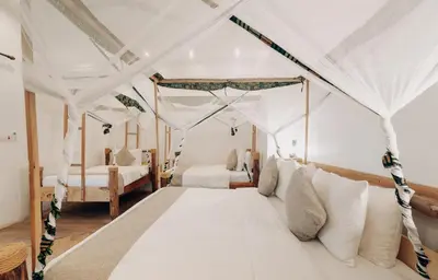 a bedroom with two beds and a canopy bed at Chanya by Ardhi Africa in Moshi