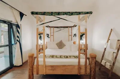 a bedroom with a canopy bed in a room at Chanya by Ardhi Africa in Moshi