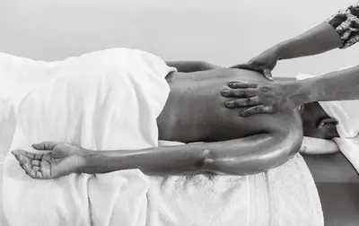 a man is laying in a bed with his hands on his back at Chanya by Ardhi Africa in Moshi