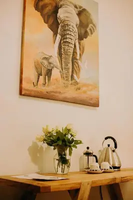a painting of an elephant and a baby elephant at Mambo Hideaway in Arusha
