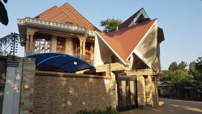 a large house with a brick wall at Cape of Goodhope Vacation Home in Arusha