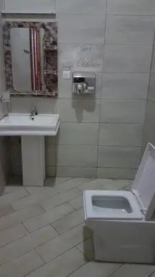 a bathroom with a sink and a toilet at Cape of Goodhope Vacation Home in Arusha