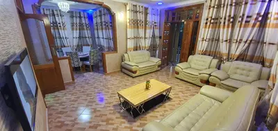 a living room with a couch and chairs and a table at Cape of Goodhope Vacation Home in Arusha