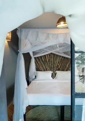 a bedroom with a bunk bed in a room at Kutoka Lodge in Arusha