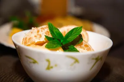a white bowl of food with a green plant in it at Kutoka Lodge in Arusha
