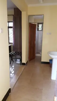 an empty room with a sink and a door at Kilimanjaro Country House in Moshi
