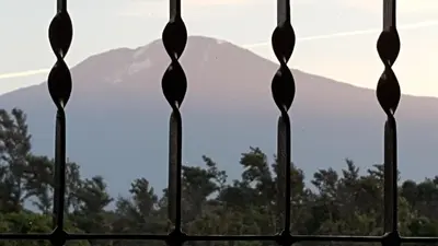 a view from a fence with a mountain in the background at Kilimanjaro Country House in Moshi