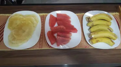 three plates of fruit and bananas on a table at Kilimanjaro Country House in Moshi