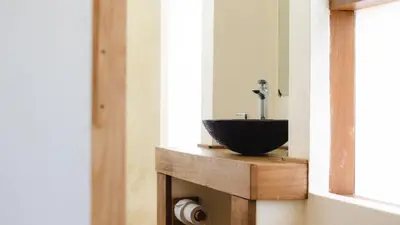 a bathroom with a bowl sink on a counter at Haradali's Home in Arusha
