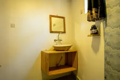 a bathroom with a sink and a mirror at Dan Stam Hotel in Arusha