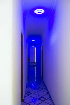 a blue hallway with a blue ceiling and a hallway sidx sidx sidx at New Favour Lodge in Arusha