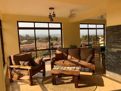 a living room with two couches and a table at Lilac Elevate Inn in Karatu