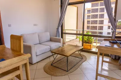 a living room with a couch and a table at Lilac Elevate Inn in Karatu