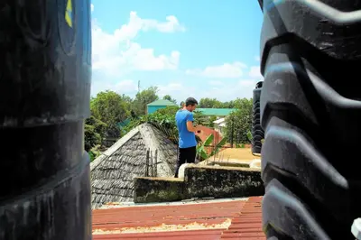 a man standing on the roof of a house at First Point Arusha Hostel in Arusha