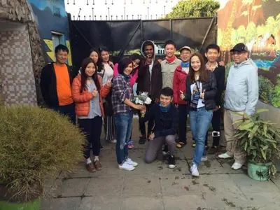 a group of people posing for a picture together at First Point Arusha Hostel in Arusha