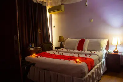 a bedroom with a bed with christmas lights on it at New Hotel Aquiline in Arusha