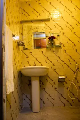 a bathroom with a sink and a mirror at New Hotel Aquiline in Arusha