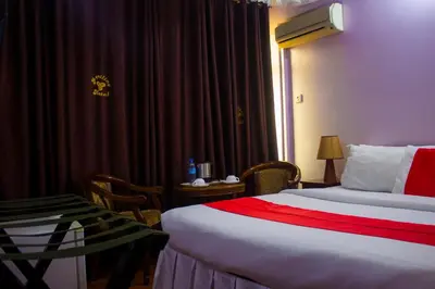 a hotel room with a bed and a table at New Hotel Aquiline in Arusha