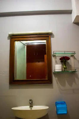a bathroom with a sink and a mirror and a window at New Hotel Aquiline in Arusha