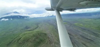 a view of a mountain from the wing of an airplane at Africa Safari Lake Natron in Mtowabaga