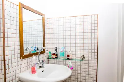 a bathroom with a sink and a mirror at Lavender Coffee Farm House in Arusha