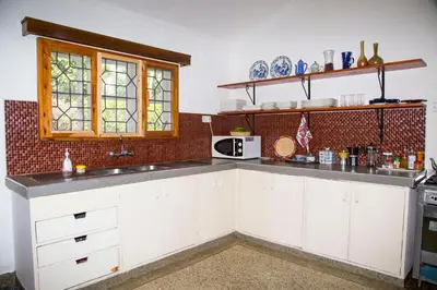 a kitchen with white cabinets and a counter top at Lavender Coffee Farm House in Arusha