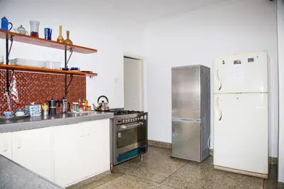 a kitchen with a stove and a refrigerator at Lavender Coffee Farm House in Arusha