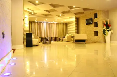 a lobby with a waiting room with white furniture at SG Premium Resort in Arusha