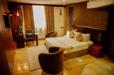 a hotel room with a bed and a desk at SG Premium Resort in Arusha