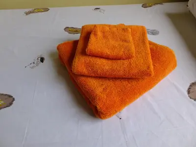 a couple of orange towels sitting on a table at Enjivai Hostel in Arusha