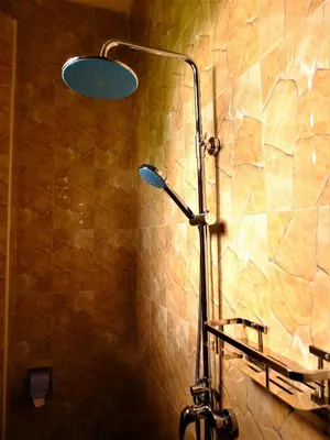 a shower with a shower head in a bathroom at Enjivai Hostel in Arusha