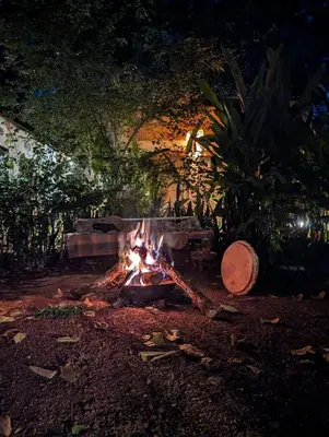a fire pit in a yard at night at Backyard Eco Bungalows Moshi in Moshi