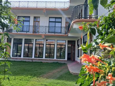 an external view of a building with large windows at Bird of Paradise Eco Lodge in Arusha