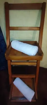 two white paper towels on a wooden chair at Mai Kilimanjaro Home Stay in Marangu