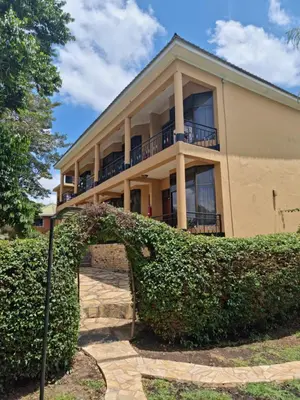 a house with a hedge in front of it at Africa Safari Arusha in Arusha