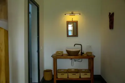 a bathroom with a sink and a mirror on a wall at Hakuna Woga Inn in Arusha