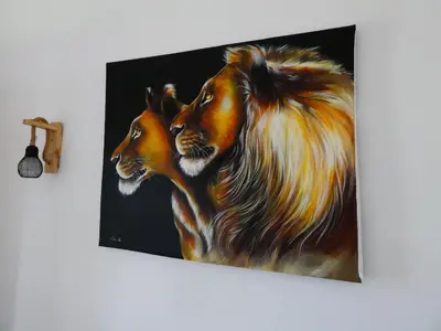 a painting of two lions hanging on a wall at Hakuna Woga Inn in Arusha