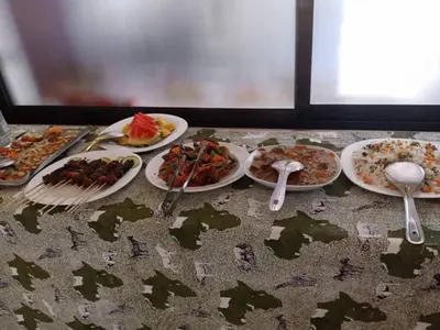 a table topped with plates of food and spoons at Africa Lodge Arusha in Nkoaranga