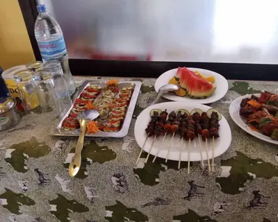 a table with plates of food and plates of food at Africa Lodge Arusha in Nkoaranga
